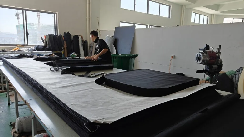 Technician assembling Aluminum Honeycomb base for hard shell roof tents. Heavy Duty manufacturing standards ensuring durability.