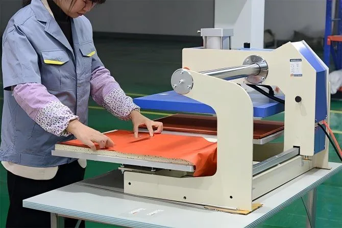 Thermal transfer machine applying Custom Logo on tent fabric. Branding Service offered by Camp Auto Parts for wholesale clients.