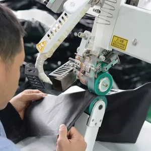 Home 43 Machine applying protective coating to tent fabric. Advanced technology for UV Resistant and durable roof top tent materials.