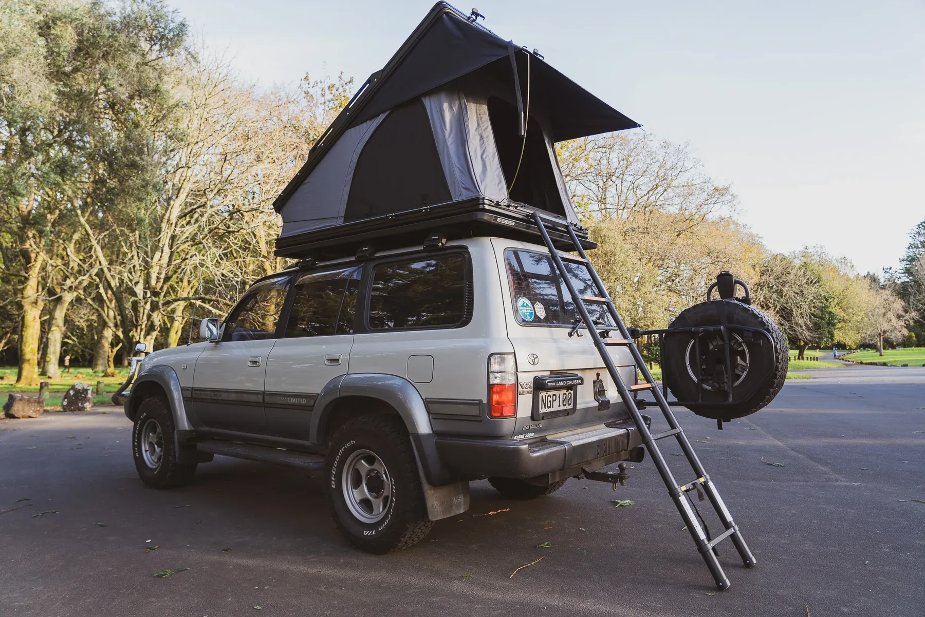Aluminum Triangle Roof Top Tent (30s Setup) | Wedge Hard Shell RTT 6 Luxury aluminum clamshell roof top tent mounted on SUV, featuring 360-degree panoramic view and aerodynamic design, manufactured by Camp Auto Parts.