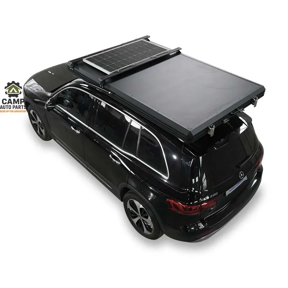 Top view of closed triangle aluminum hard shell roof top tent with 120W solar panel and cross bars mounted on SUV, manufactured by Camp Auto Parts.